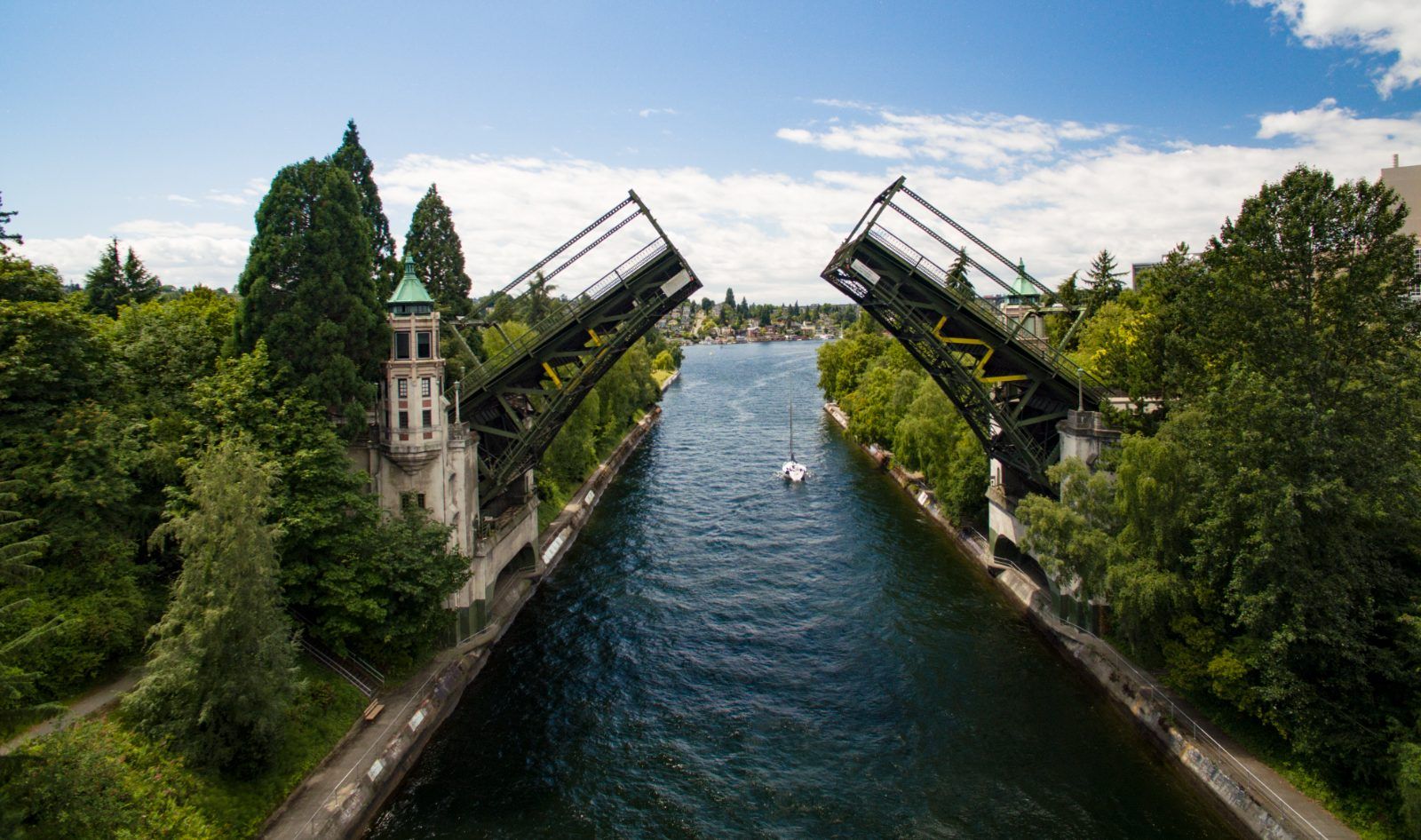 Montlake Bridge raised over the water, with trees lining both shores